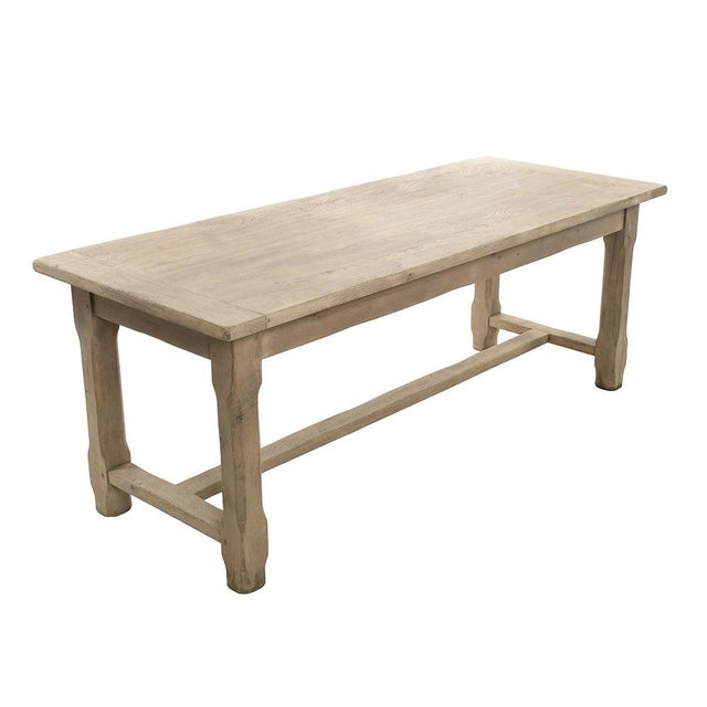 Large oak farm table having been sanded. This piece is designed in the style of the selected designer and/or manufacturer