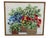 Mid century 1970s era needlepoint floral wall art. The art depicts multiple potted plants. A colorful piece of art. Framed...