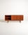 Scandinavian teak sideboard with sliding doors, four central drawers, and carved wooden handles. Swedish production from...