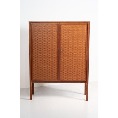 Leo bub for bub wertmöbel cabinet with ‘woven’ front. The design of this teak highboard from teak and teak veneer is...