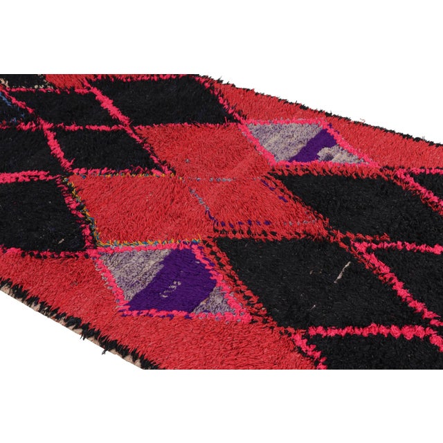 Hand-knotted in wool and originating from Morocco circa 1950-1960, this 4x8 vintage Moroccan rug is an extremely rare...