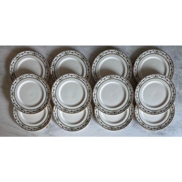 Set of 12 beautiful early 20th century Royal Doulton dinner plates featuring a white body and fine trellis and floral...
