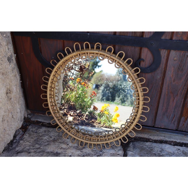 Round rattan mirror with a twisted design. A beautiful, iconic rattan piece by Franco Albini, Italy. Dating from the...