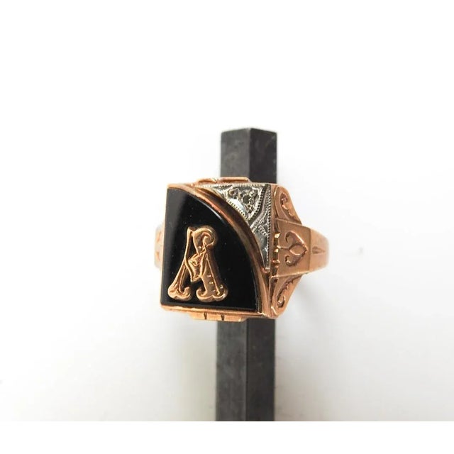 Early 20th century 10K, black onyx and tiny diamond initial "A" ring by Kinsley & Sons, Gothic. Marked inside of band,...