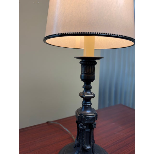 A finely detailed Neoclassical table lamp crafted entirely from solid brass. The base features ornate classical detailing...