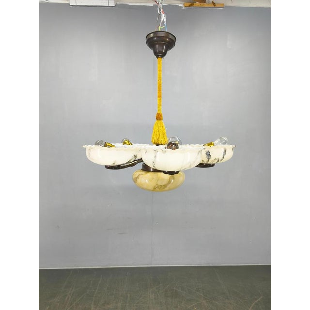 An exceptional art deco chandelier produced in czechoslovakia during the 1940s, featuring five elegantly shaped marble-...