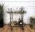 Beautiful and stylish 1960s Hollywood Regency Italian two-tier brass and smoked glass bar cart. A great piece that...