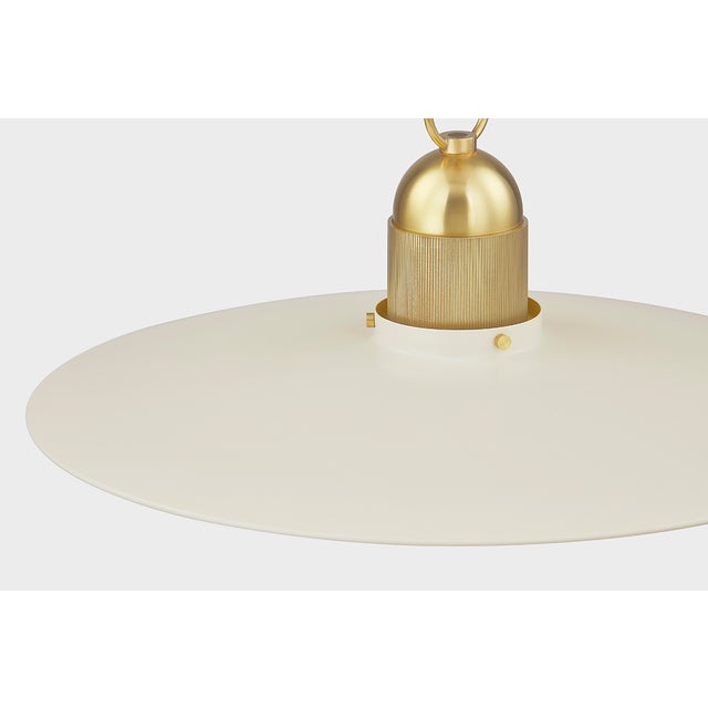A beautifully modern take on the farmhouse pendant, Leanna features a very slim reflector shade in Soft Cream or Soft...