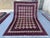 This richly detailed Khal Mohammadi rug features a dense diamond lattice in crisp ivory, filled with delicate floral and...