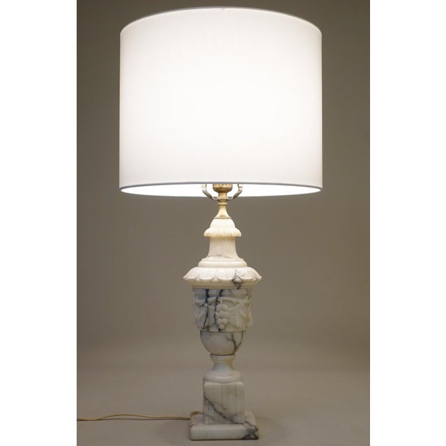 A sophisticated and elegant milky White Carrara Marble & Brass Neoclassical Urn table lamp designed and manufactured in...