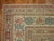A lovely antique Persian doroksh rug featuring accents of soft blue and burnt orange set on an open camel ground, circa...