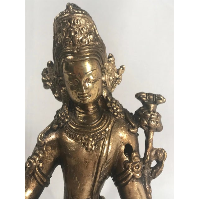 19th Century Gold Gilded Bronze Buddha A finely cast bronze Buddha statue in gold gilt with modeled and incised floral...