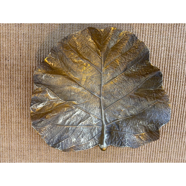 This sea grape leaf dish was made by Virginia Metal Crafters and has a copyright of 1949. It is made of a brass-like...
