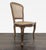 Wood carved chair with cane back and seat. Dimensions (in): 19W x 18D x 36H.