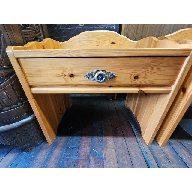 Beautiful pair of 1960s Swedish mid-century modern nightstands. Crafted from solid pine, these tables showcase a warm,...