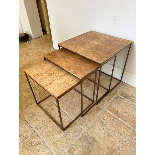 Set of 3 square nesting tables with burlwood tops on heavy brass base. Tables sizes are 24", 22" and 20".