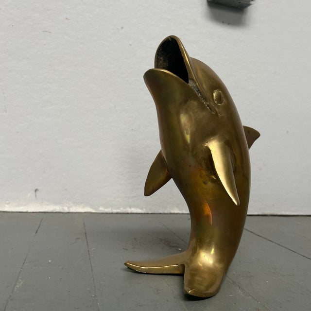 1980’s original brass standing dolphin statue. Measures approximately 10 inches high, 5.5 inches wide and 8 inches deep....