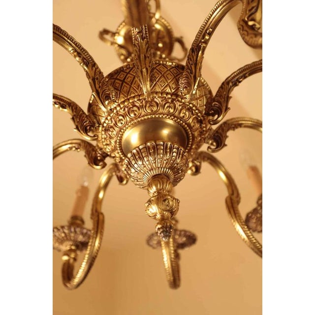 Large gilded bronze ten-arm chandelier in the classicist louis xvi style. The chandelier is elaborately detailed. High-...