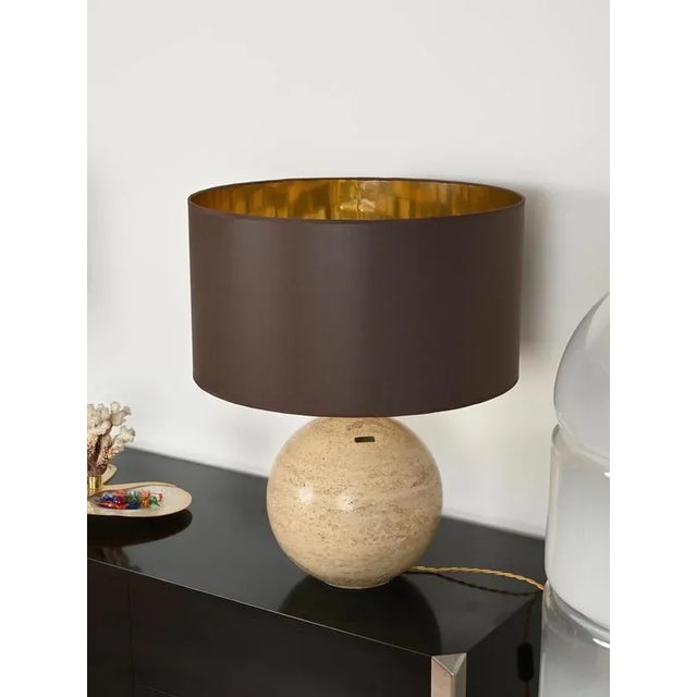 Extraordinary large sculptural italian table lamps made in solid travertine marble and brass, completed by a round brown...