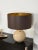 Extraordinary large sculptural italian table lamps made in solid travertine marble and brass, completed by a round brown...