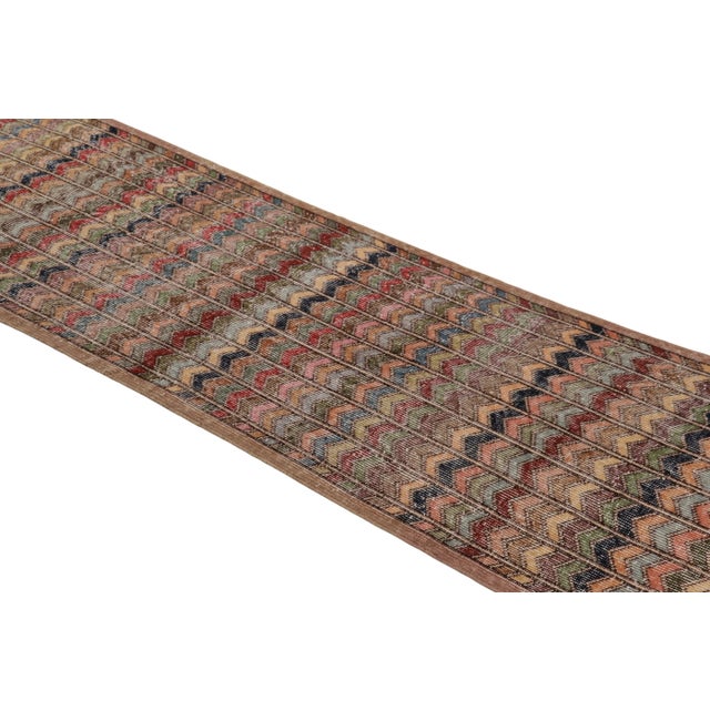 Made with hand-knotted wool circa 1950-1960, this 3x10 vintage Turkish runner rug of all over chevron geometric design is...