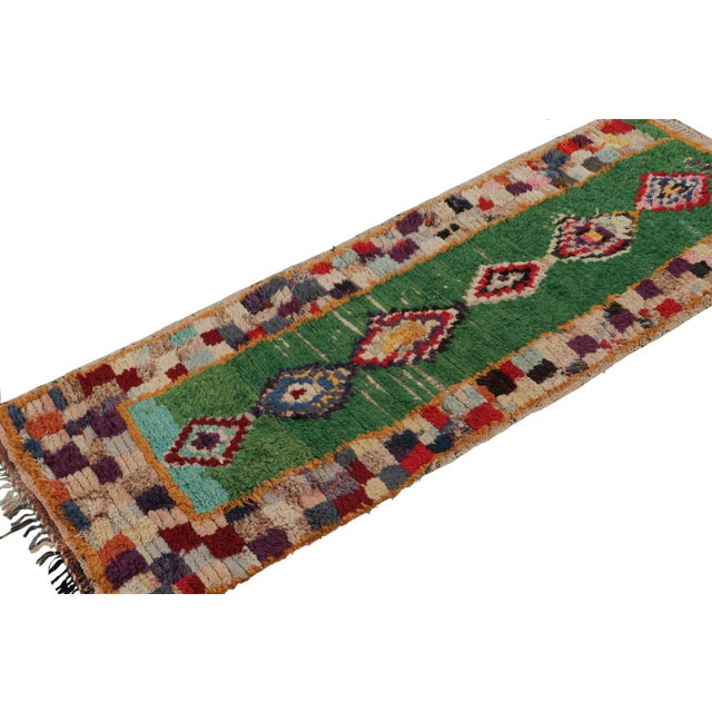 Hand-knotted in wool and circa 1950-1960, this 2x6 vintage Moroccan rug is believed to hail from the Azilal tribe. On the...