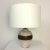 Ceramic table lamp, circa 1940, france. brown ceramic, white glazed decor, in the style of jean besnard. new white fabric...