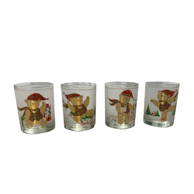 A delightful set of four happy bears Christmas glasses by Culver featuring gold accents and playful holiday charm, perfect...
