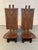 Make a striking design statement with this pair of low-slung carved chairs featuring bold geometric forms and a commanding...