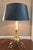 Style in the manor of 18th-century French Bouillotte design. It features decorative scrolled tripod feet. Matte black...