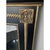 Offered is a striking statement wall mirror. This mirror features beveled glass, solid wood black frame with gold accents....