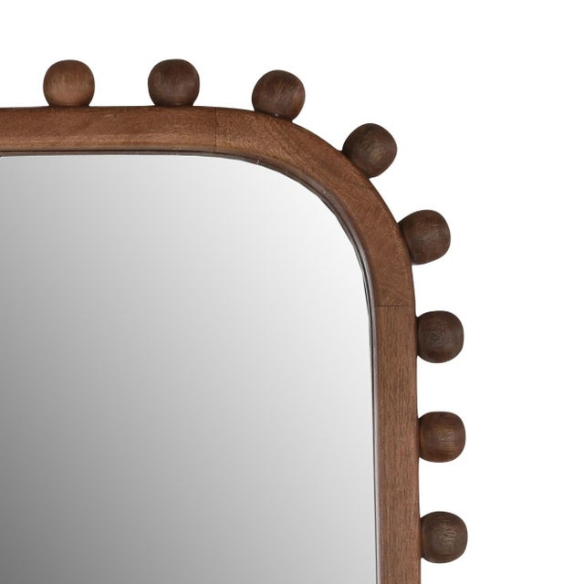 Solid mango wood frame mirror with playful modern ball edge design. Beautiful dark brown finish. Each may vary in exact...
