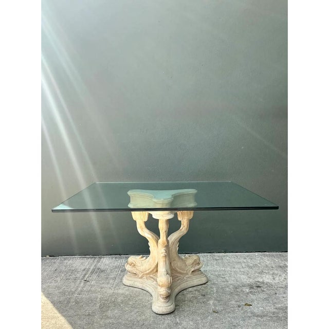 This vintage dining table features a striking plaster base sculpted with a classic Neoclassical dolphin motif. Three...
