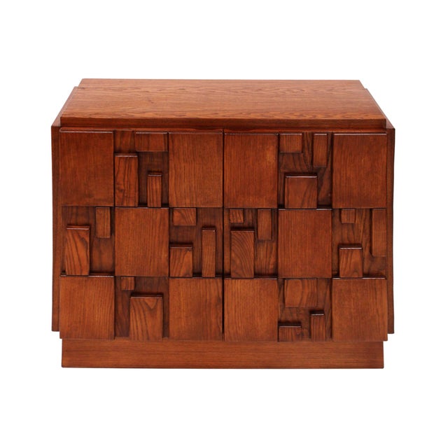 A striking pair of brutalist-style sideboards handcrafted in solid oak, showcasing a bold geometric façade composed of...