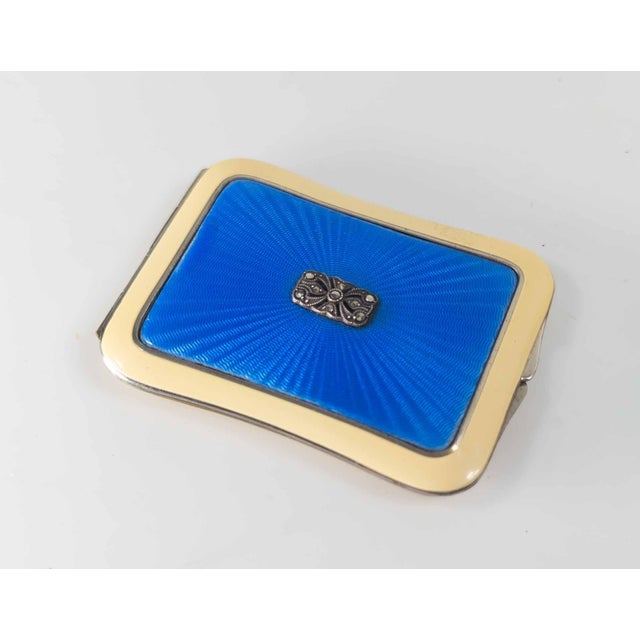 We are selling this great looking Mid-century make up compact. This compact has beautiful bright blue guilloche enamel...