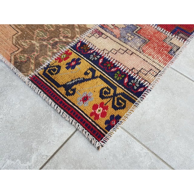 This is a vintage Turkish Oushak rug from the Mid 20th Century. The piece was hand-knotted.