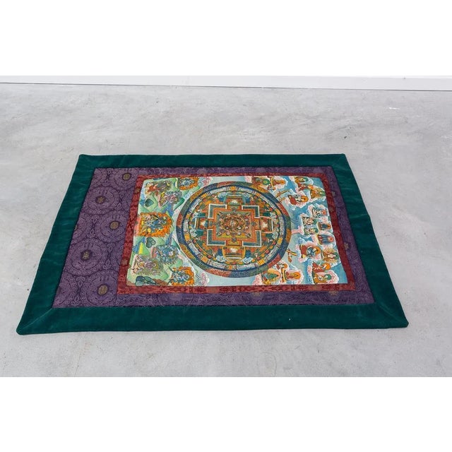 Pair of Thangka, or Thanka, paintings made by hand on felling, with scenes from the life of the Buddha and other deities,...