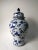 his blue and white porcelain jar is adorned with hand painted lovely birds on the tree branches. Antiquing process applied...