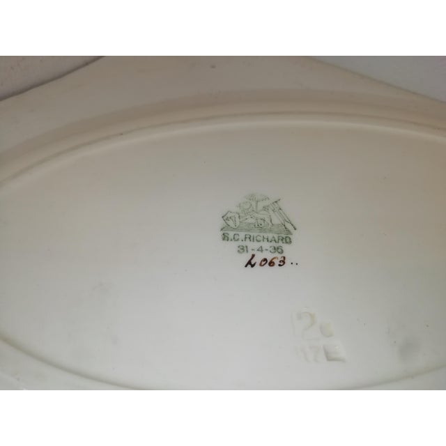 Splendid ceramic plate designed by Gio Ponti for Richard Ginori. Elegant design with orange border and stylized sail in...