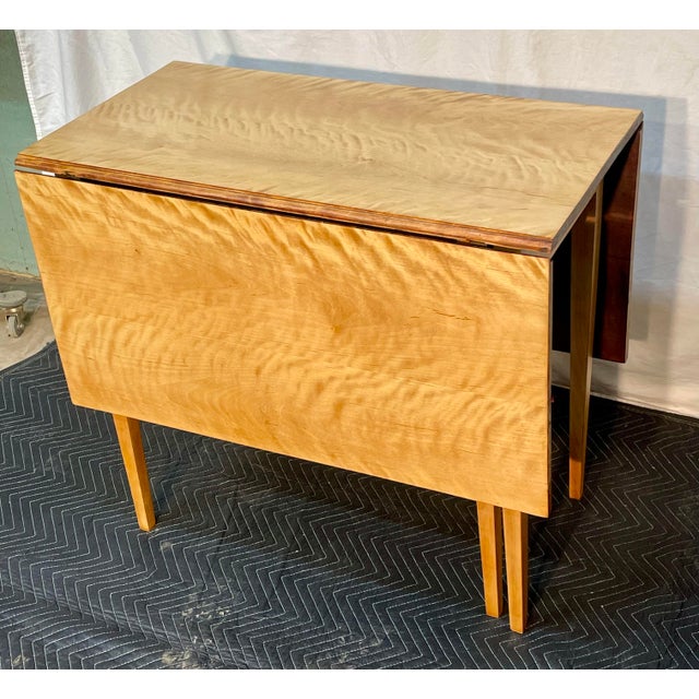 Presenting a masterwork of regional craftsmanship: the Pennsylvania Bench-Made Curly Maple Gate Leg Table. The Allure of...