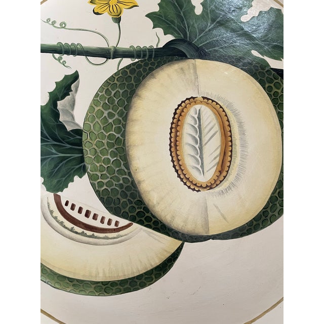 The Habitat International hand-painted metal tole tray with a 20” diameter is a decorative piece inspired by Americana...