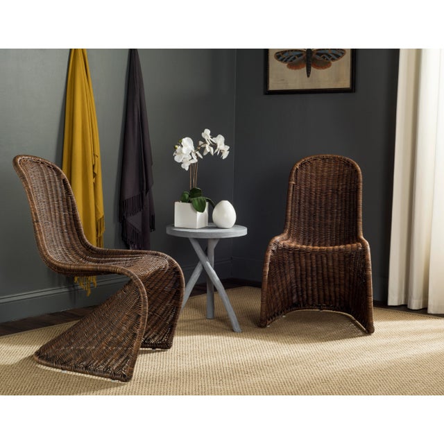 This contemporary wicker side chair is reminiscent of Verner Panton’s Danish design classics. Crafted in a neutral shade...