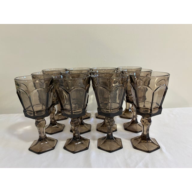 A striking vintage find for the collector of mid-century glassware — this set of twelve Fostoria goblets features paneled...