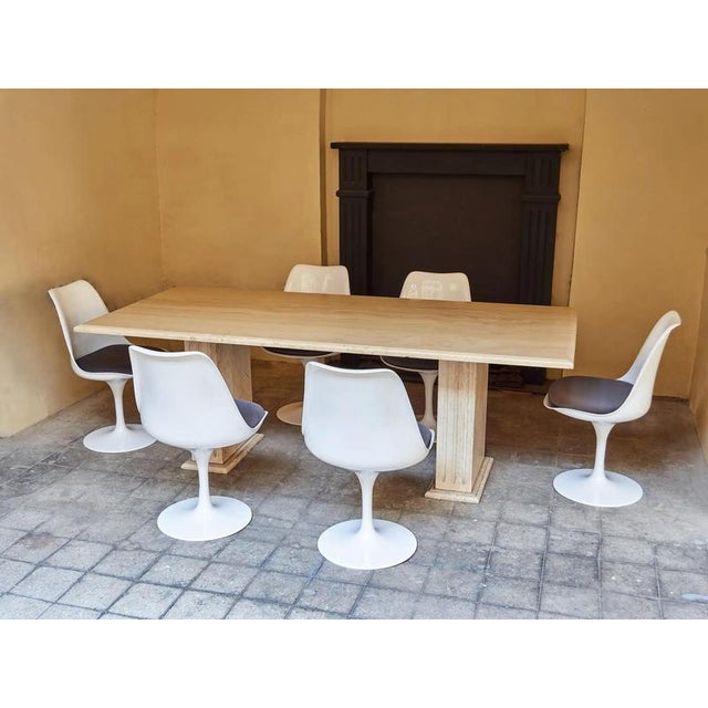 We offer an elegant and timeless dining table made of natural travertine, made around the 1970s. The table will impress...