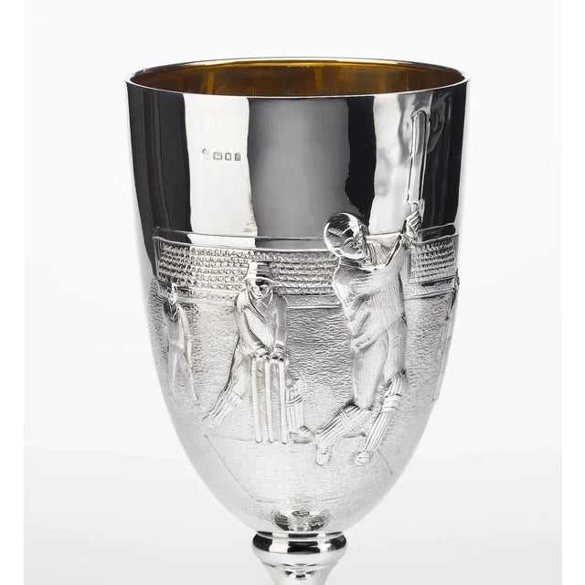 This is a handsome sterling silver trophy dating to circa 1923. Detailed in raised relief on the the goblet-shaped trophy...