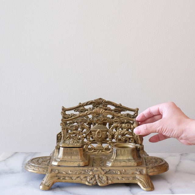 Antique brass inkwell, in good overall condition (there are spots of wear/tarnishing on the brass). A beautiful piece for...