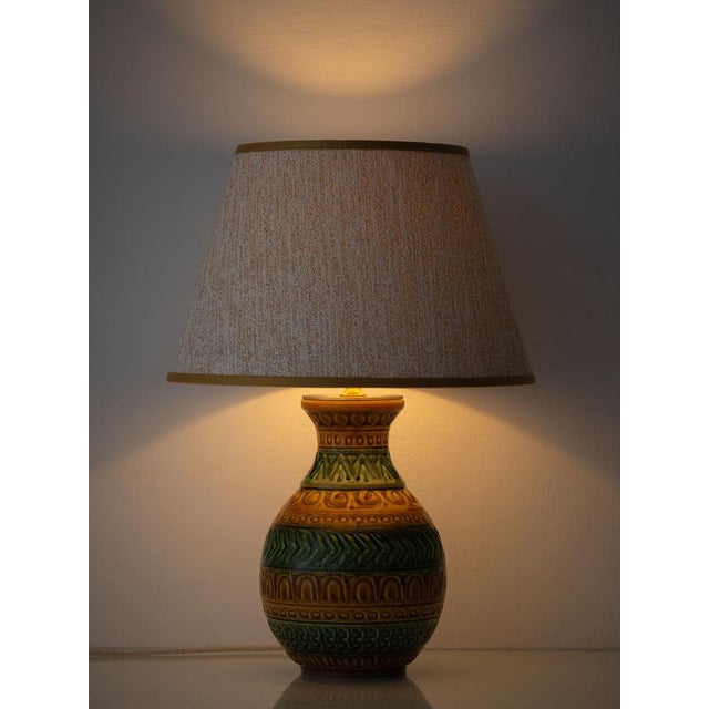 A West German ceramic table lamp in the incised, geometric style of Aldo Londi's Bitossi pottery, here in earthy moss...