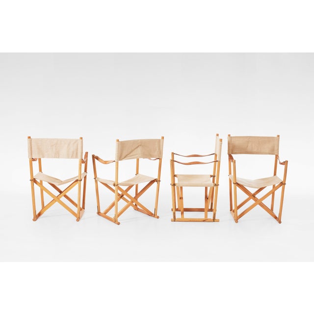 Designed by Mogens Koch in 1932 and produced by Rud. Rasmussen, this set of 4 Folding Chairs fuses historical campaign...
