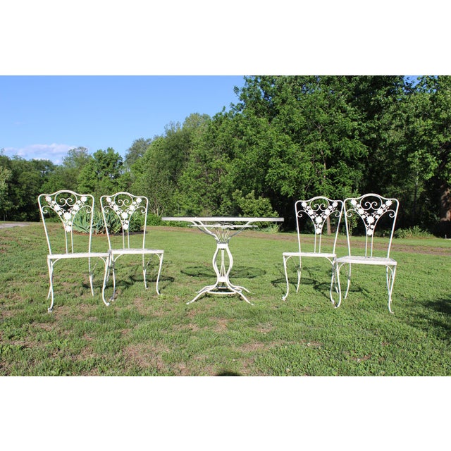 I have acquired yet another wrought iron patio set with an abundance of vintage character and flower motifs. This one was...