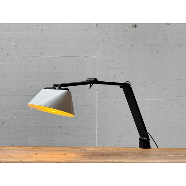 An architecturally designed clamp lamp from the 1970s, created by franco mirenzi and vittorio parigi for the italian...